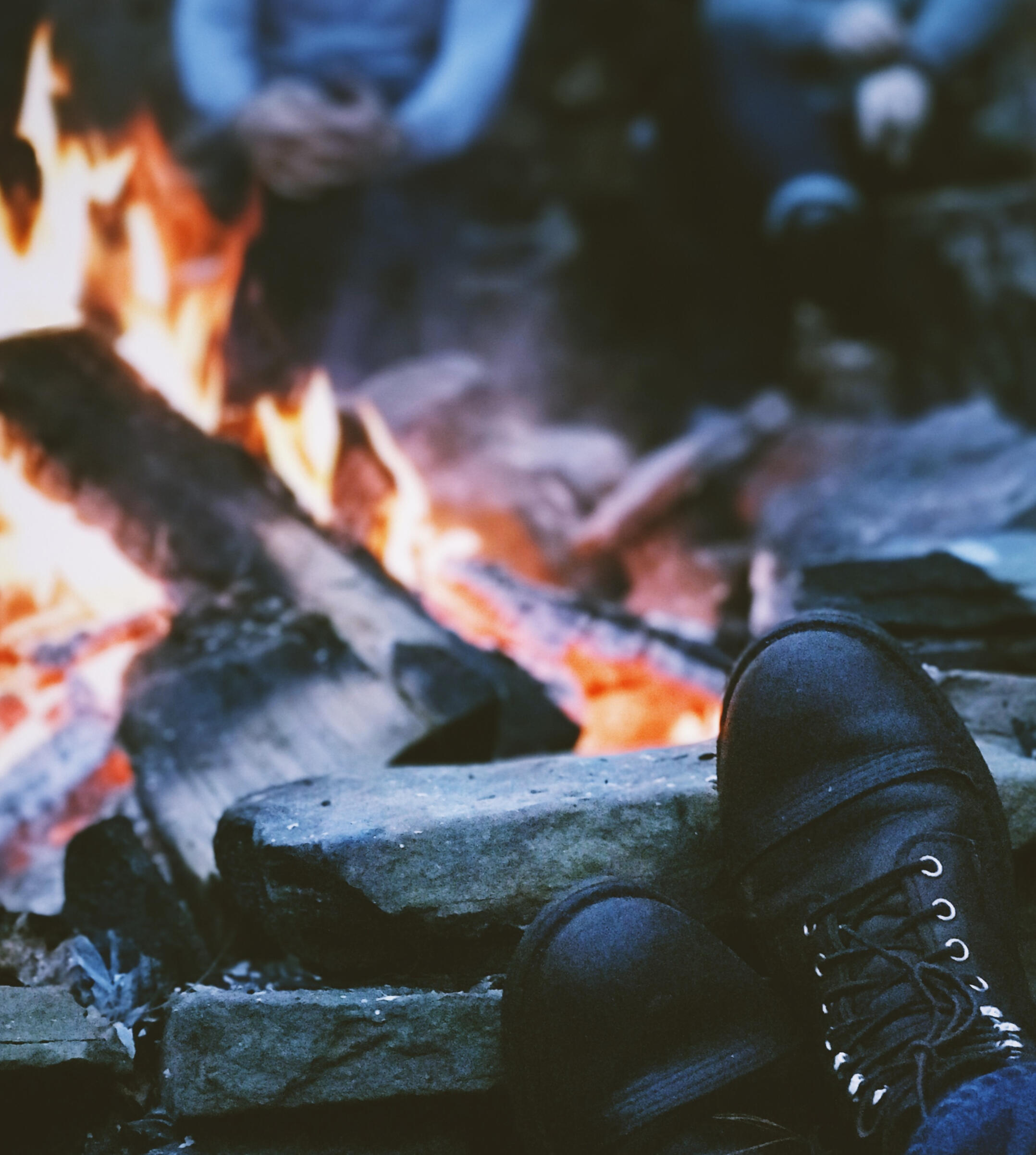 A small group sitting around a campfire
